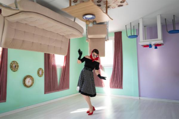 Woman standing in upside-down room