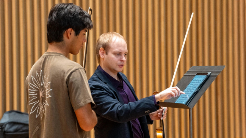 Violin teacher and student talking