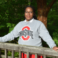 Anaiyah Rogers standing outside with an Ohio State crewneck on
