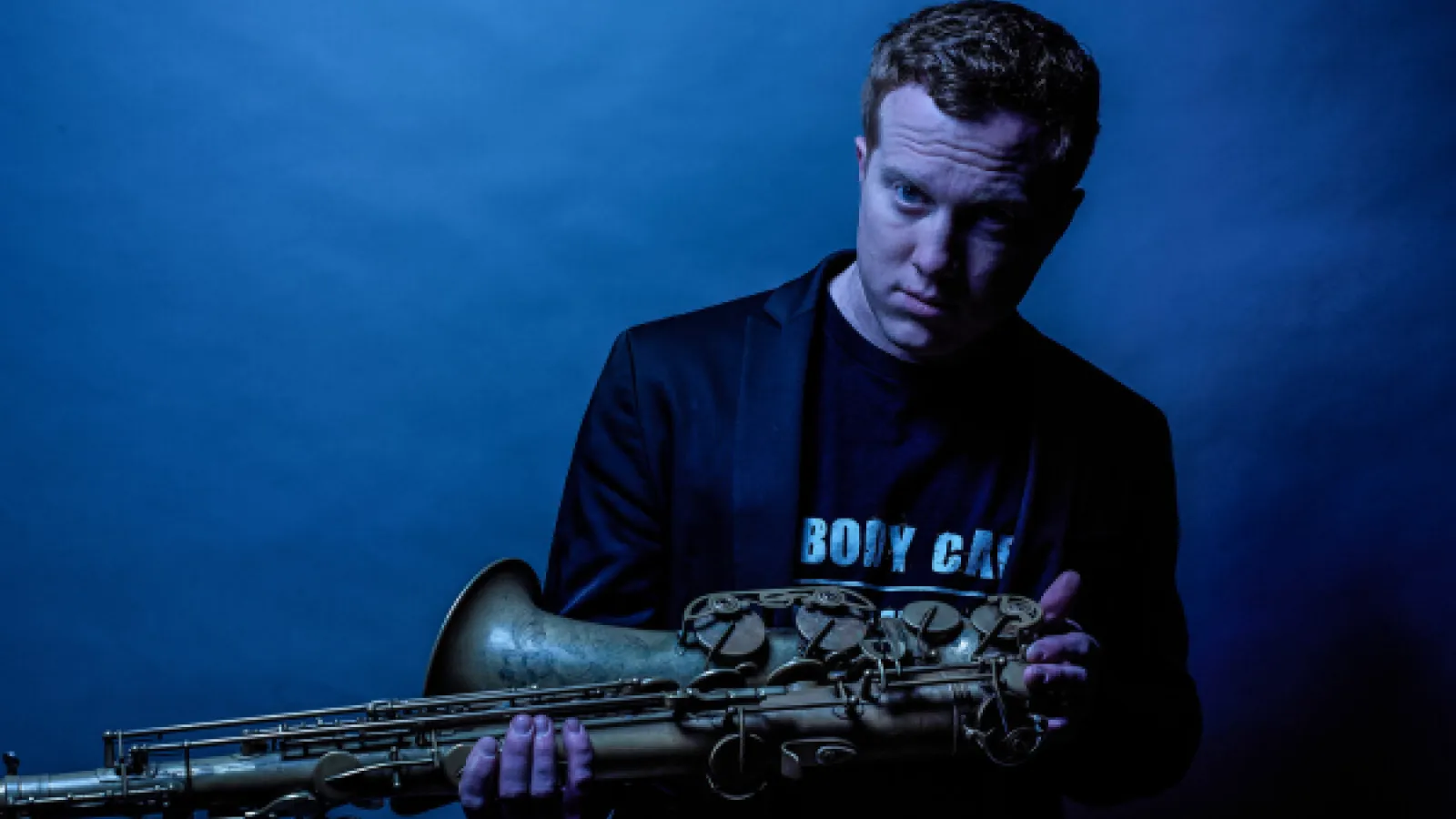 Guest Artist Adam Larson holding his saxophone
