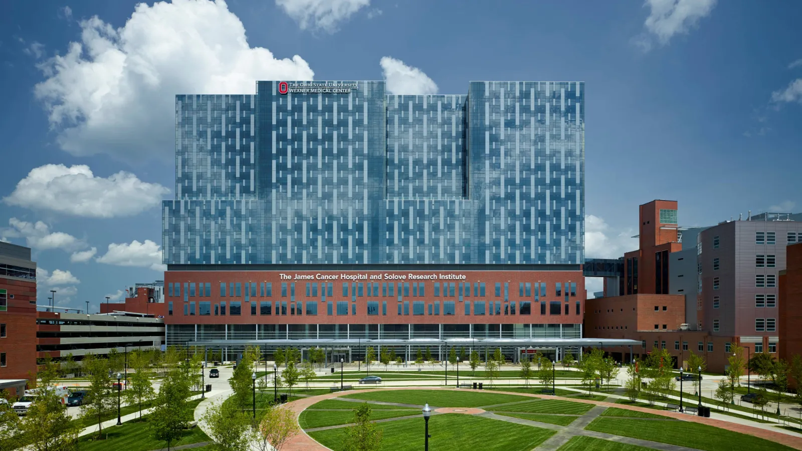 The James Cancer Hospital, against blue sky with clouds