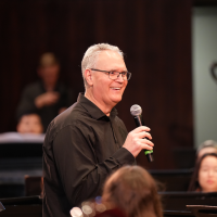 Dr. Mikkelson talking to the Wind Symphony