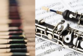 Oboe reeds and oboes atop music score