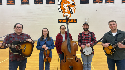 Five musicians holding various string instruments 