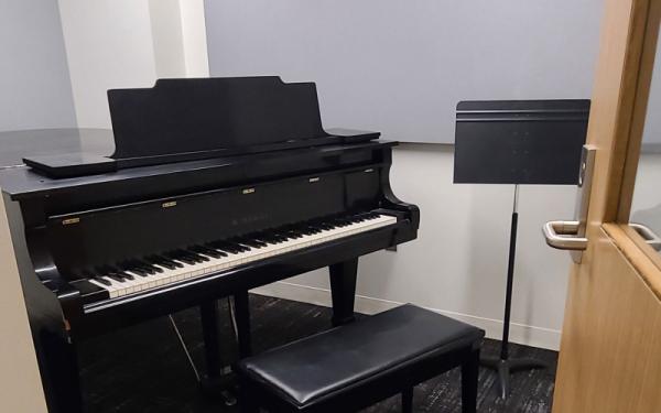 Practice room with piano and music stand