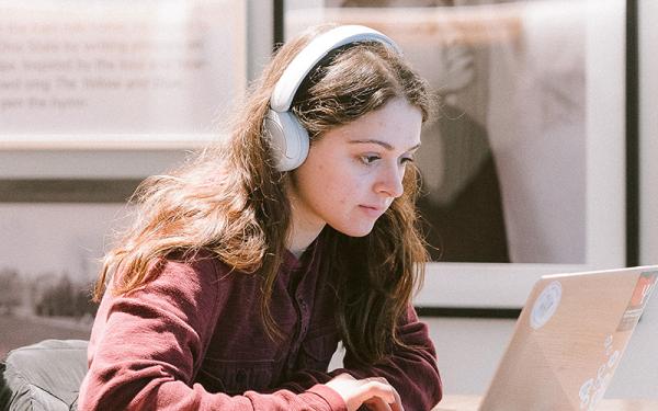 Student studying wearing headphones