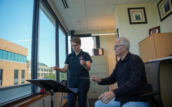 Faculty teaching conducting lesson