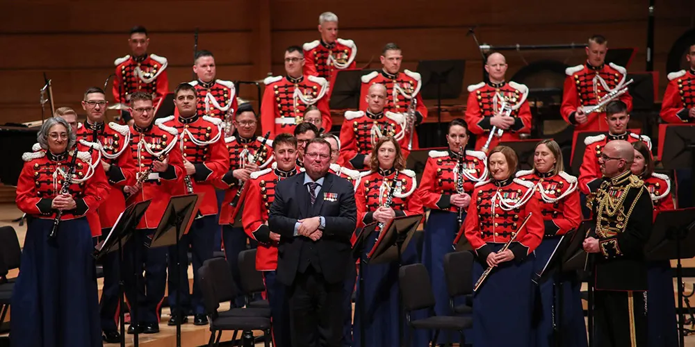 Rose and U.S. Marine Band facing appreciative audience