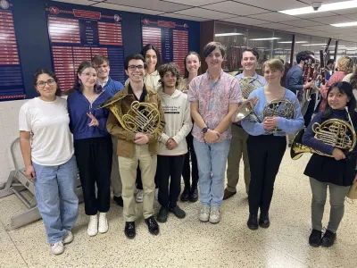 High school and Ohio State students posing with instruments