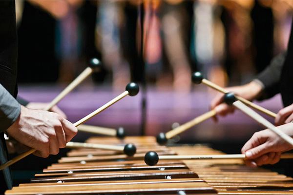 Hands of percussionists playing marimba