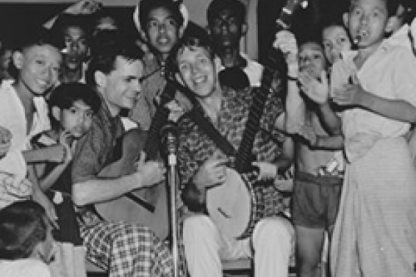 Bill Crofut and Steve Addiss, American folk singers, with children in Burma (now Myanmar). Photo courtesy of Danielle Fosler-Lussier.