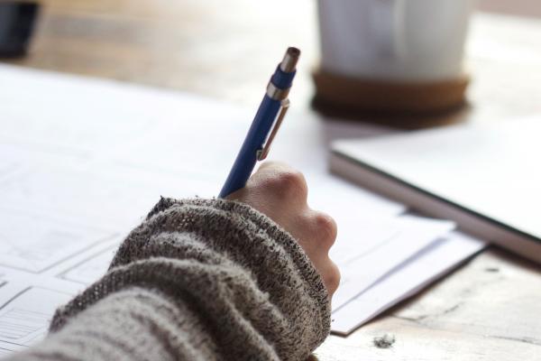 A student writing. Photo: Green Chameleon on Unsplash A student writing. Photo: Green Chameleon on Unsplash