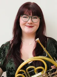 Female holding a french horn