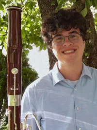 Man holding a bassoon